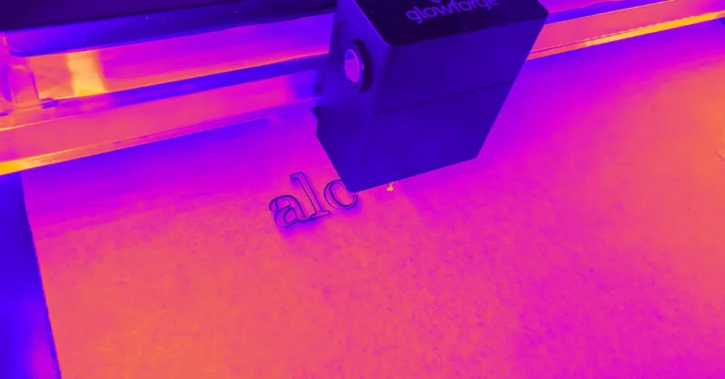 Logo being laser engraved onto acrylic to be used in their store